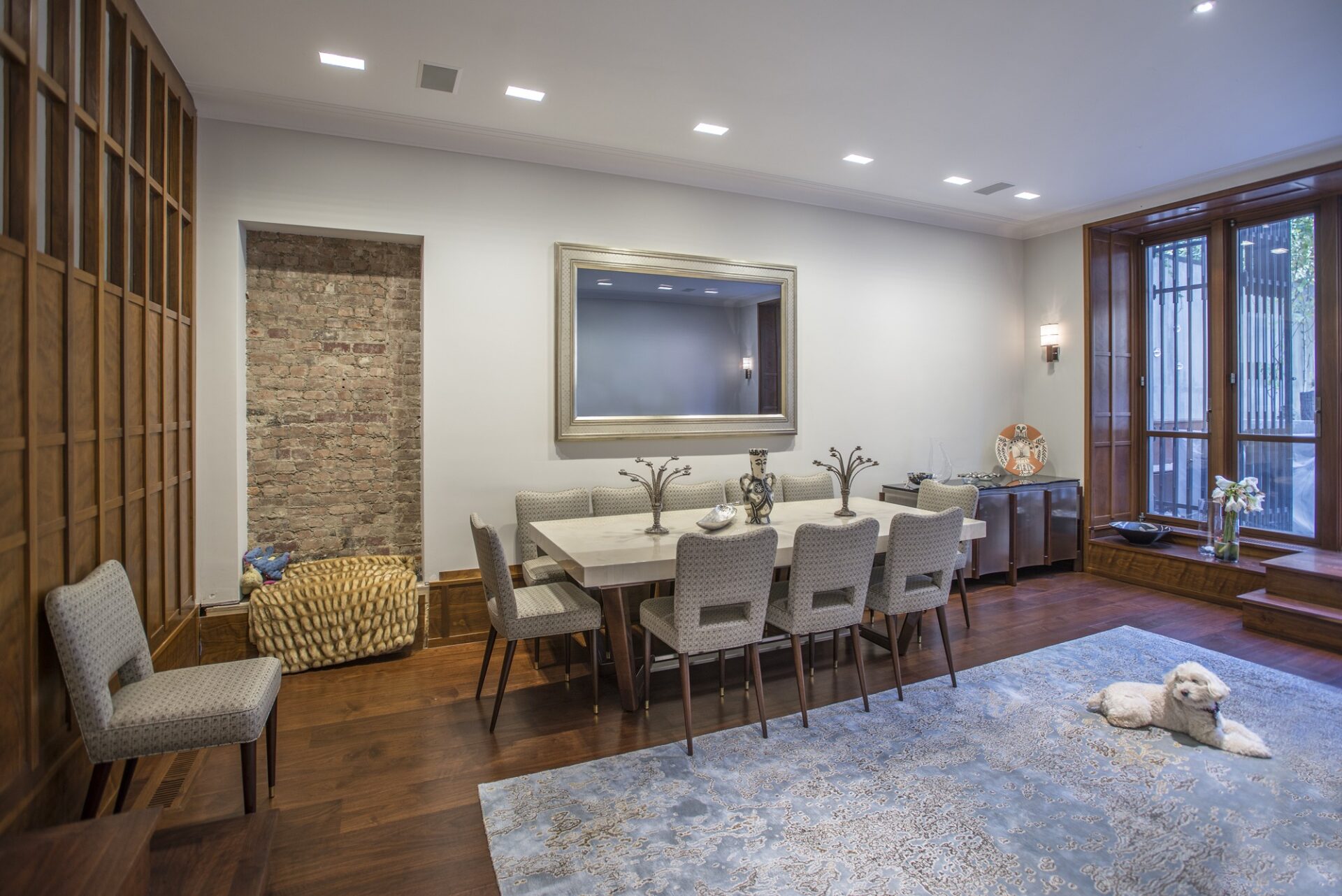 turned off gold reflectel mirror tv hangs over dining room table