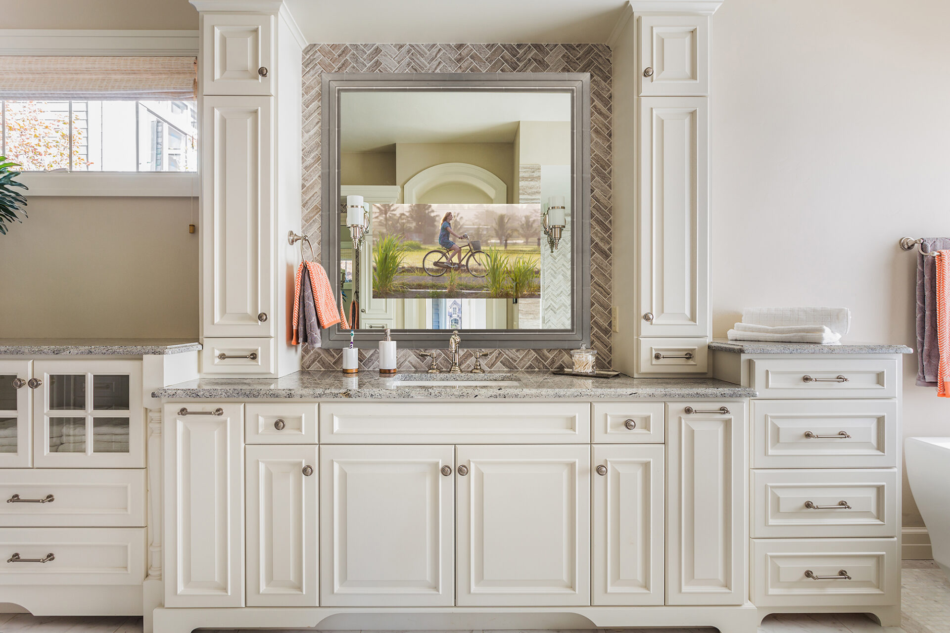 reflectel mirror tv hangs over a sink in a bathroom while on