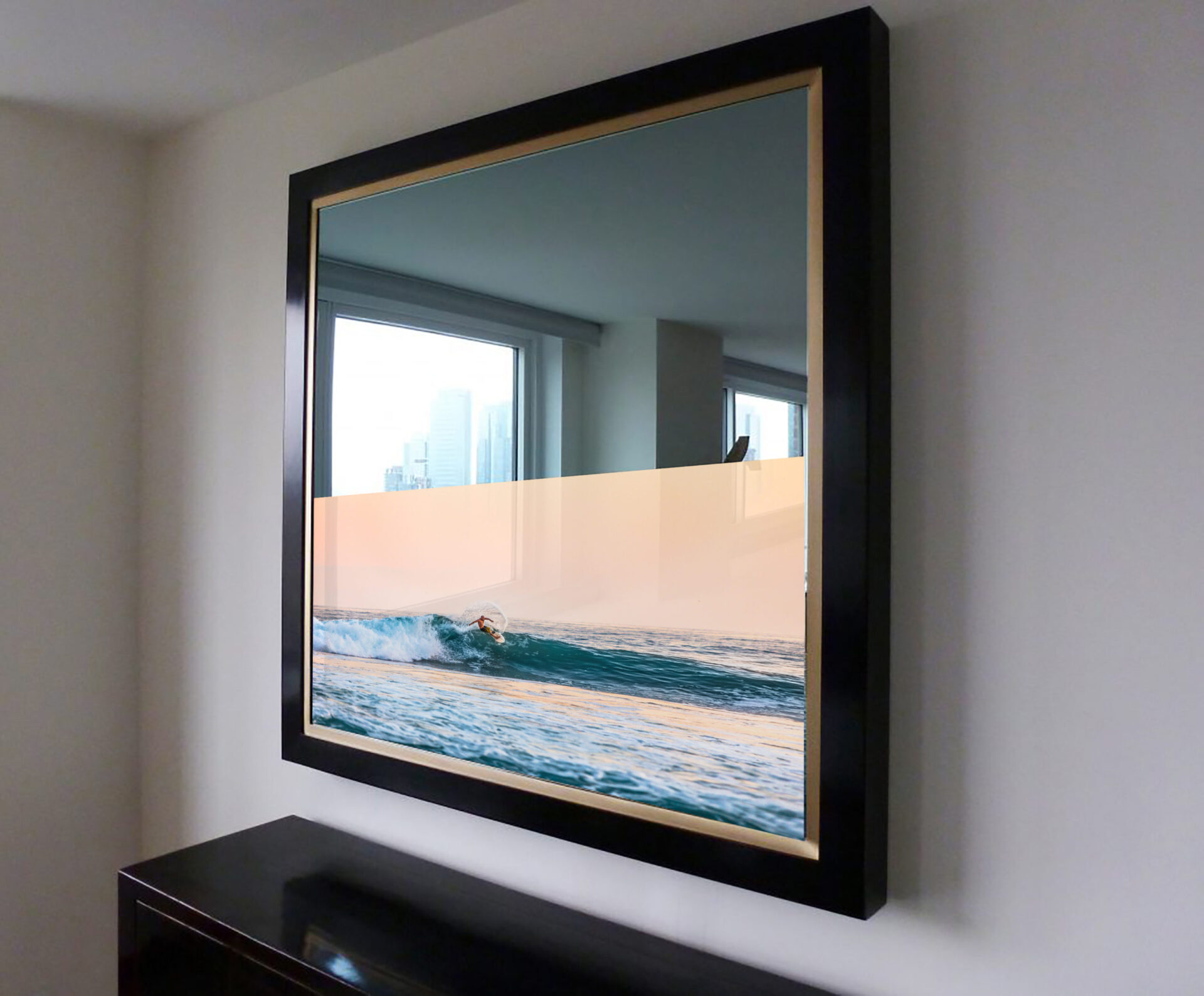 blue and gold framed reflectel mirror tv hangs over furniture on white wall