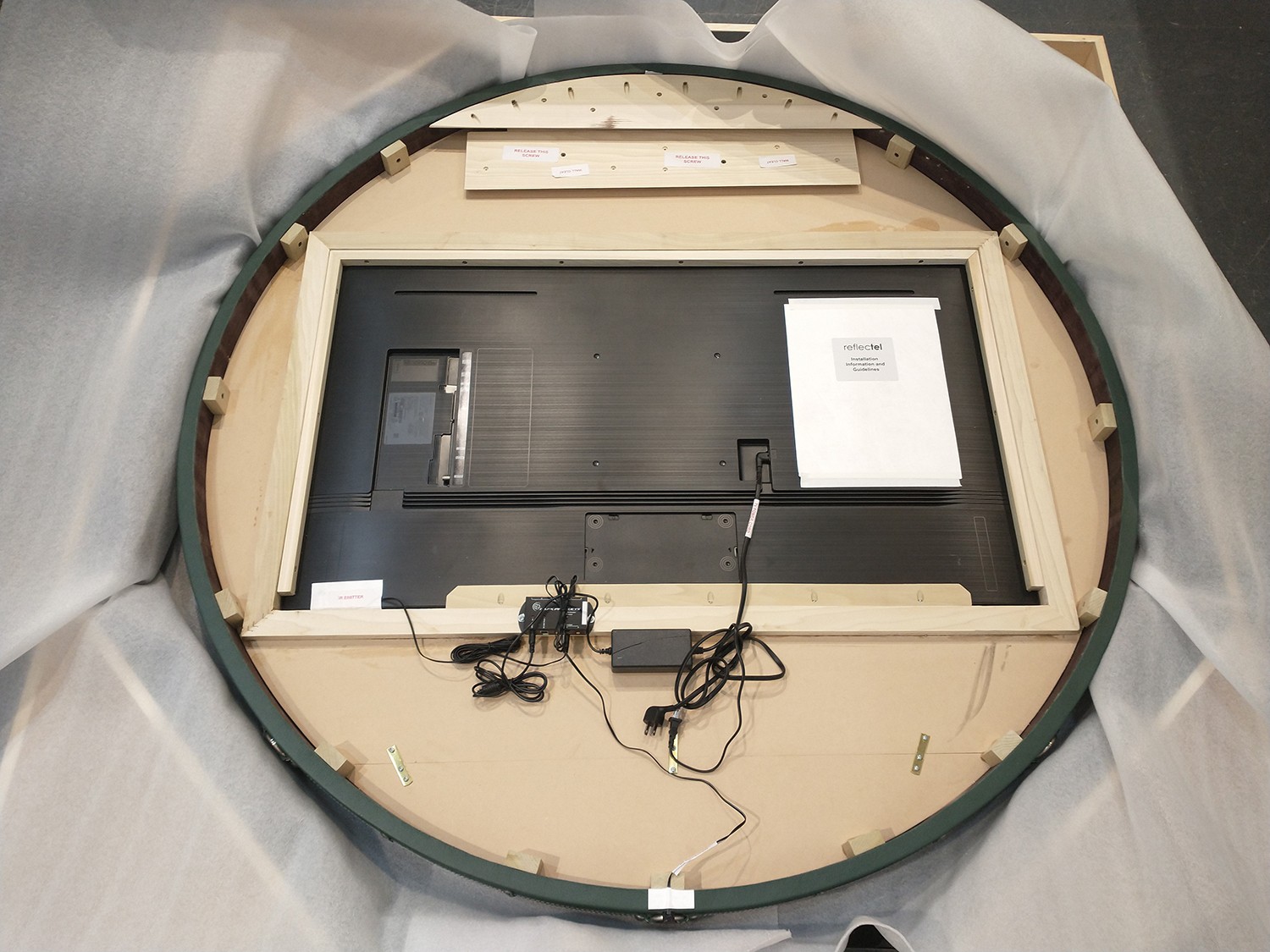 Circle Mirror TV packed in a crate with the back view showing