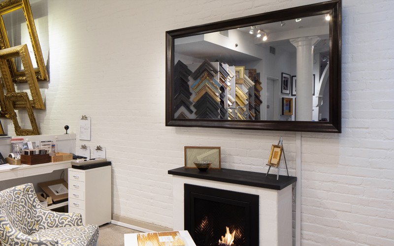 Reflectel NYC Showroom With A Mirror TV Over White Fireplace