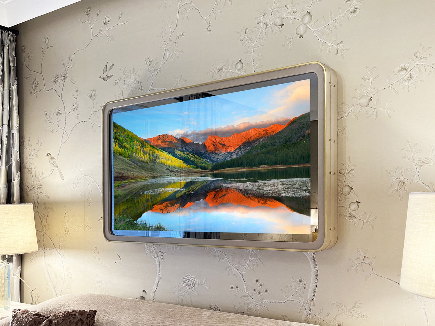 Framed Mirror TV with rounded corners over a light pink couch