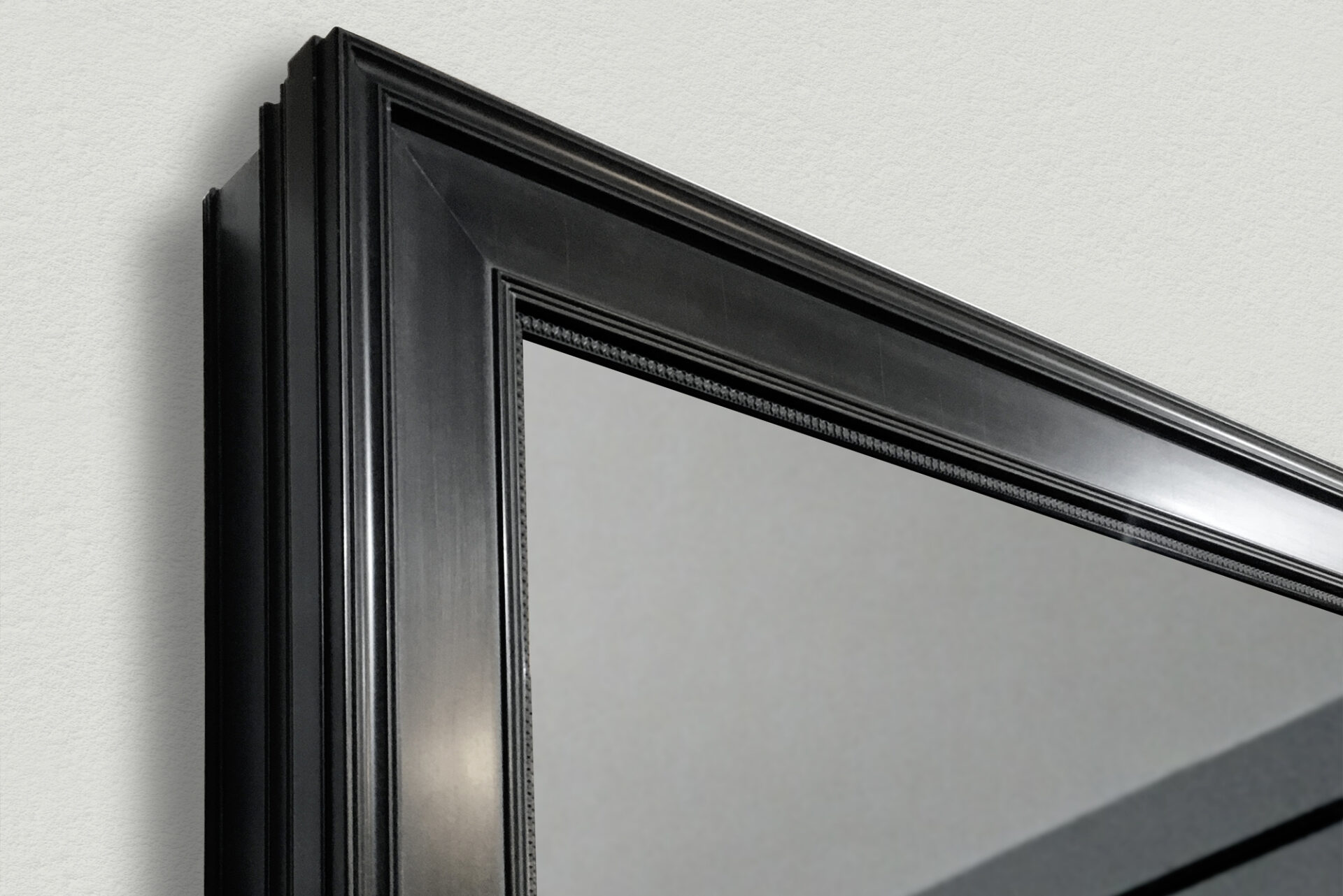 Corner Of A Mirror Television With Traditional Black Frame