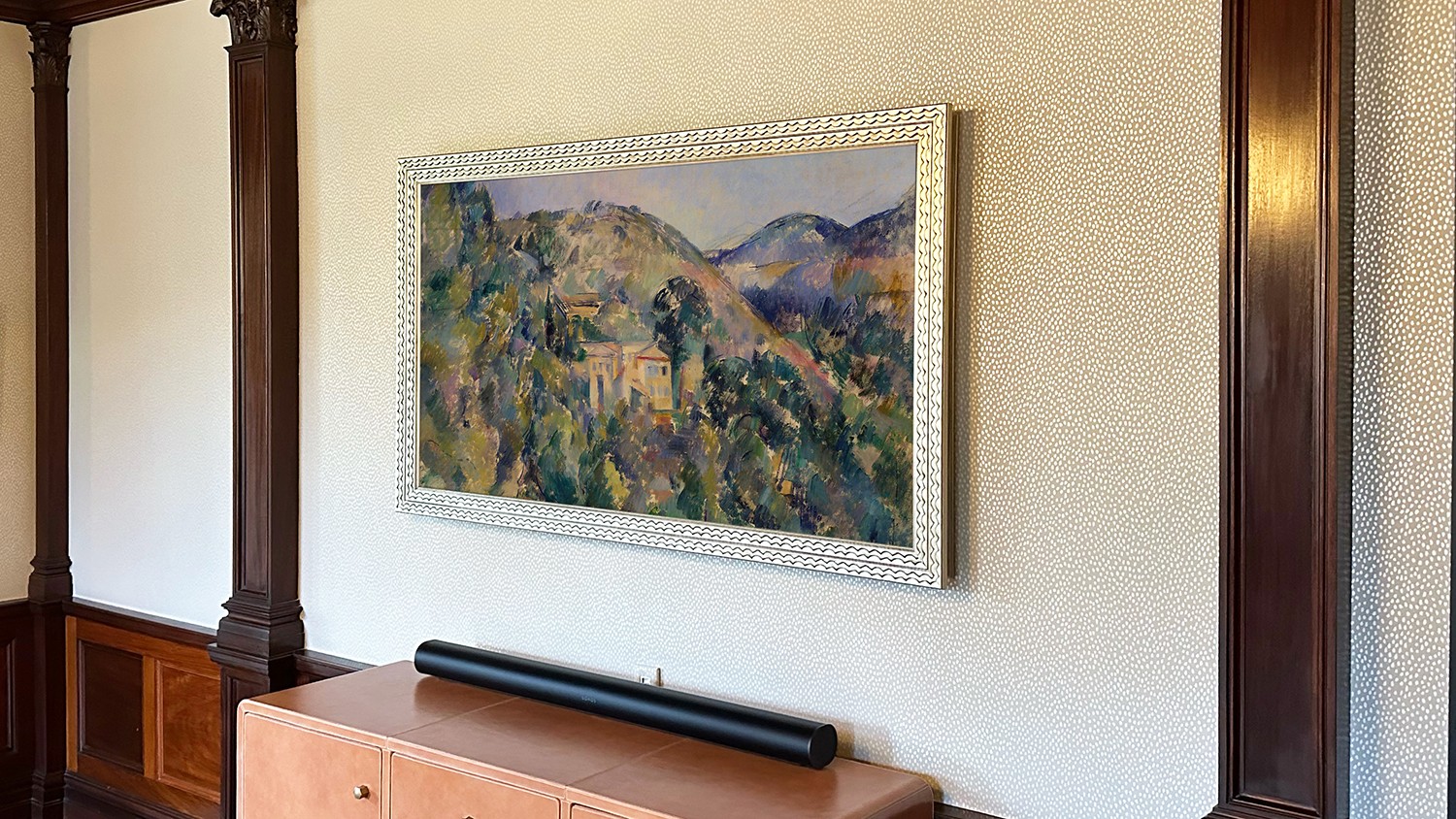 Art shown in framed TV with silver carved frame