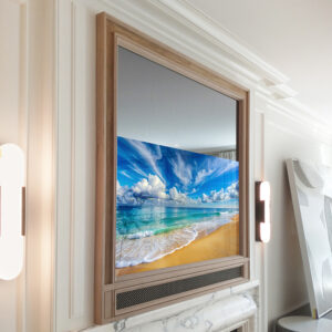 Recessed TV Mirror in a square shape with a light wood frame and metal grill soundbar cover over