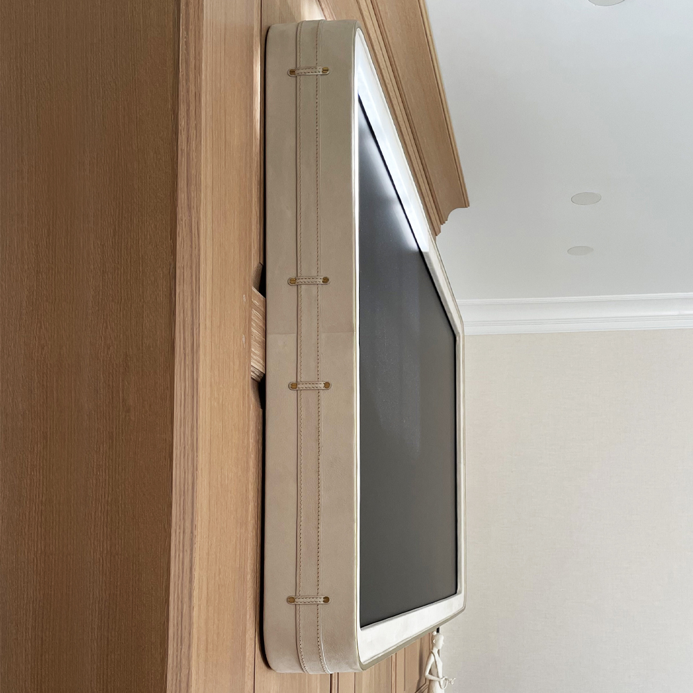 Framed Television With A White Leather Rounded Corner Frame And Side Detailing