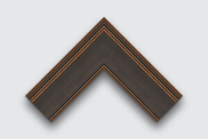 Dark brushed frame corner sample with red-gold accents