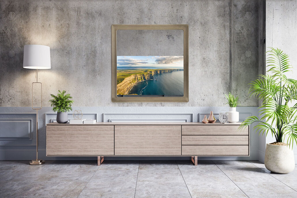 new swoop sculptural mirror tv frame over credenza in living room with gray interiors