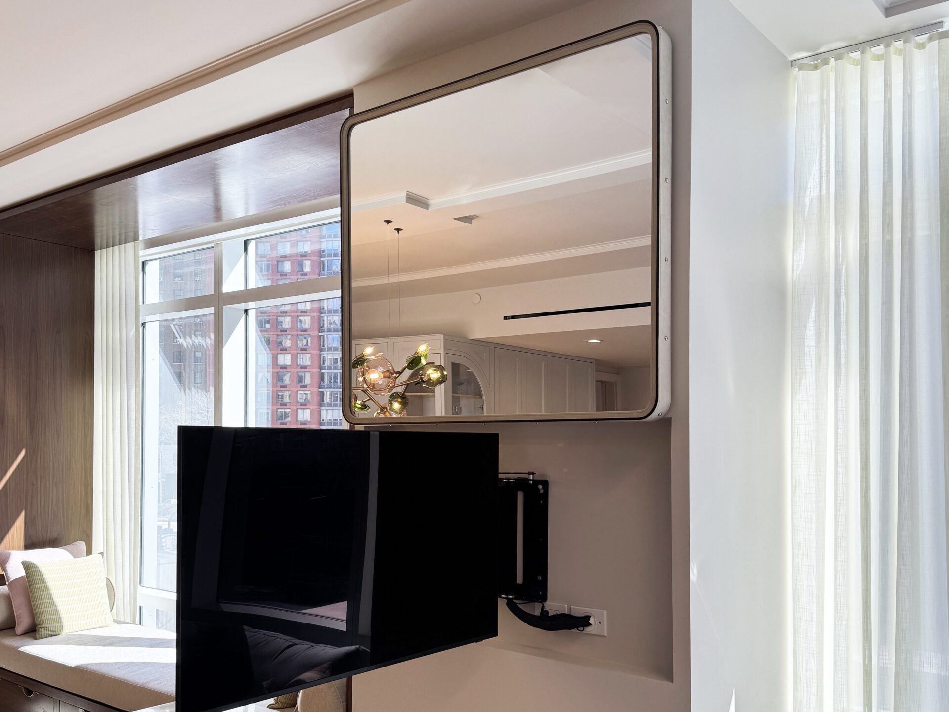 framed mirror hiding tv behind mirror with articulating arm motorized concealment