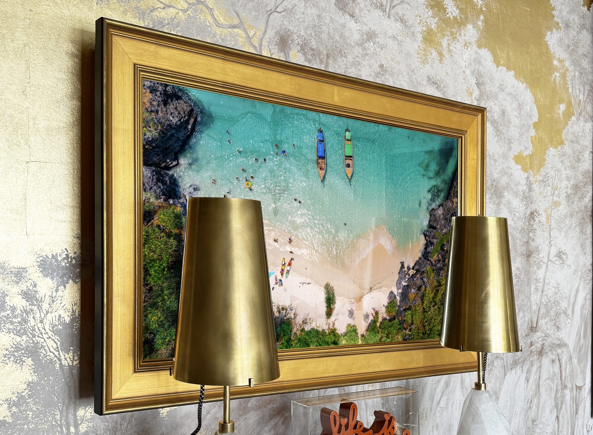 gold framed tv mirror with gold lamps in front at kips bay showhouse palm beach