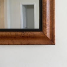 Specialty Wood - SW17 Birdseye Maple tawny birdseye maple frame corner with black mahogany liner white wall