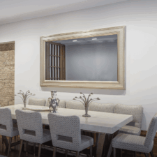 77" Landscape - Gilded Carved Samsung OLED Mirror TV in an American whistler style white gold frame over luxury dining room table with silver accents in NYC Townhouse