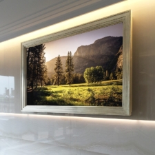 75" Landscape - Gilded Shaped The Best gilded step frame in landscape orientation framed hidden mirror tv in upscale NYC apartment over white marble fireplace