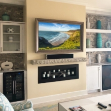 65" Landscape - Custom Finish Wood custom finished wooden framed television over a modern stone fireplace