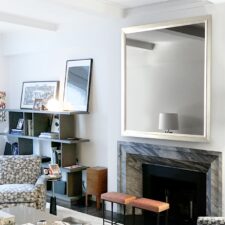 55" Portrait Plus - Gilded Shaped white gold large portrait mirror television in nyc home and dark marble fireplace