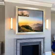 55" Square - Gilded Shaped square mirror tv with custom white gold finish and black liner over modern fireplace
