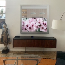 55" Square - Signature Elite The best samsung sony lg 55" television with silver modern flat 3" signature frame installed over a living room credenza