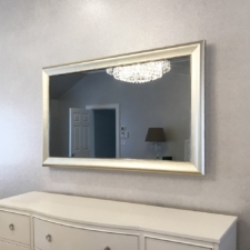 55" Landscape - Gilded Shaped white gold framed television with ambient mirror over white bedroom dresser