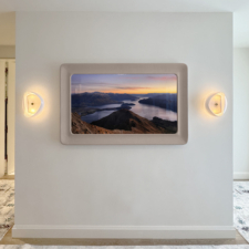55" Rounded Corner Landscape - Cortina Leathers Rounded corner leather frame Mirror TV with light blush frame on wall between sconces
