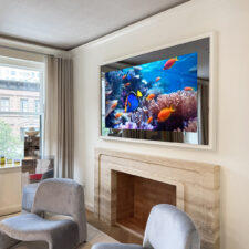65" Landscape Plus - Modern Wood to mimic millwork mirror television with a white painted frame recessed into wall over mantel