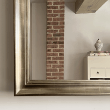 Gilded Shaped expensive gilded detailing on a mirror tv frame corner nyc home