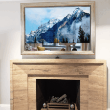 55" Landscape Plus - Gilded Shaped white gold mirror tv step frame over mantle with Sonos soundbar and Samsung TV
