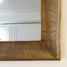 Gilded Carved - Metal Leaf Textured warm gold framed mirror television corner close up