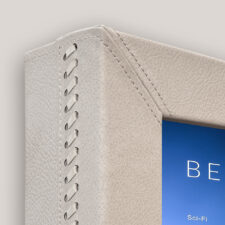 Leather - L70-COR-LIL Cream leather frame corner with woven details close up.