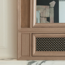 Oak Wood Frame with a Metal soundbar cover Corner of a TV Mirror with a light oak frame with metal soundbar cover