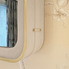 Round Corner - White Leather Rounded corner of Mirror TV frame in white leather with gold stitching