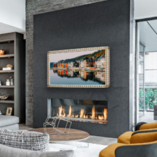 55" Landscape TV Frame - Leather white and gold leather frame with diamond pattern television over modern fireplace