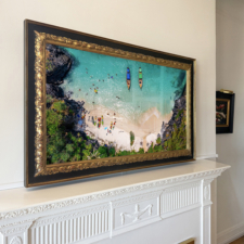 50" Landscape - Gilded Carved - Austin Texas black and gold carved Mirror TV frame over a traditional white fireplace mantel