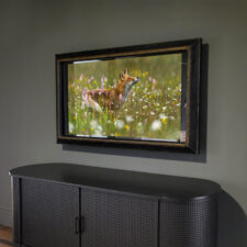48" Landscape Plus - Leather (basketweave) Palm Beach Florida Mirror TV with a leather basketweave frame over a black rounded credenza