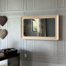 55" Rounded Corner Swoop - Leather - Nikki Levy Interiors - Holiday House Wellington Cortina Leathers Mirror TV in a rounded swoop frame profile on a paneled grey wall